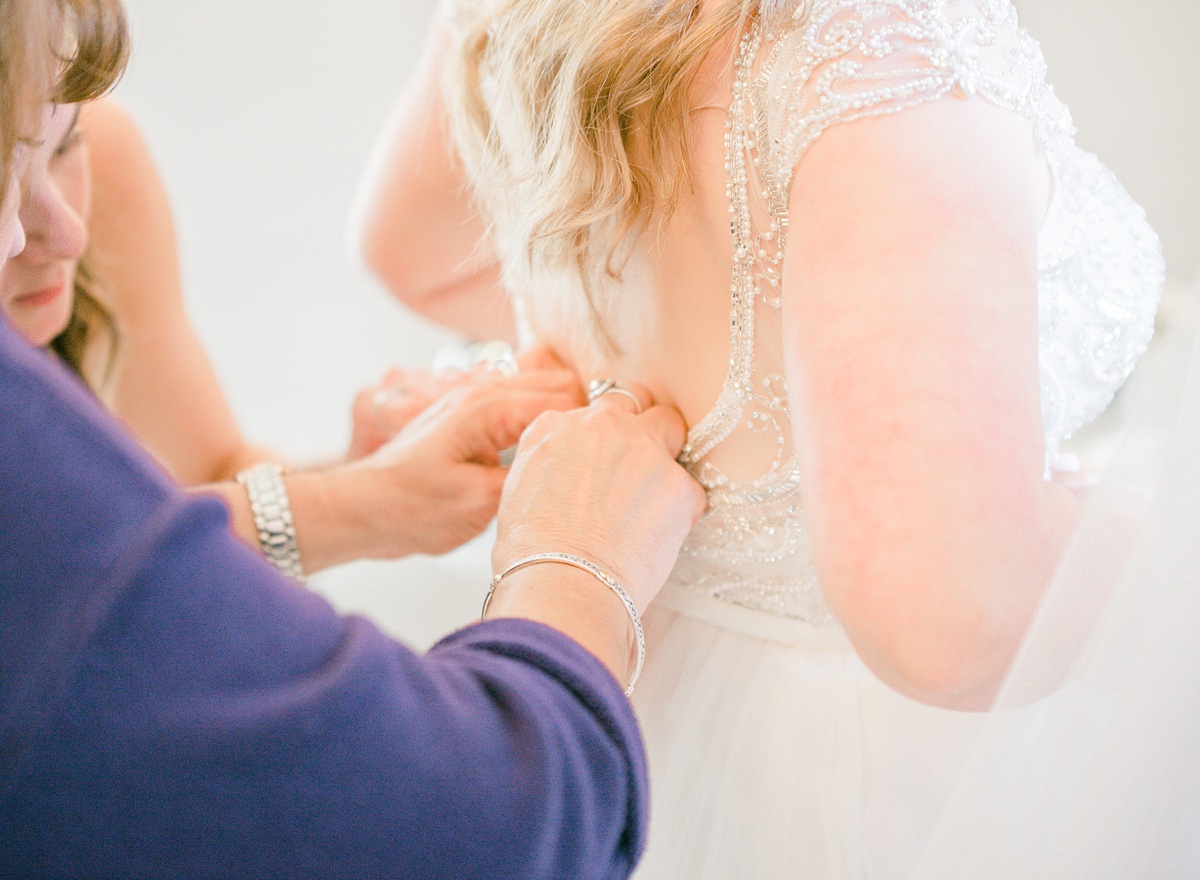 bride putting on dress,  the ivory oak wimberley wedding venue, tara lyons photography