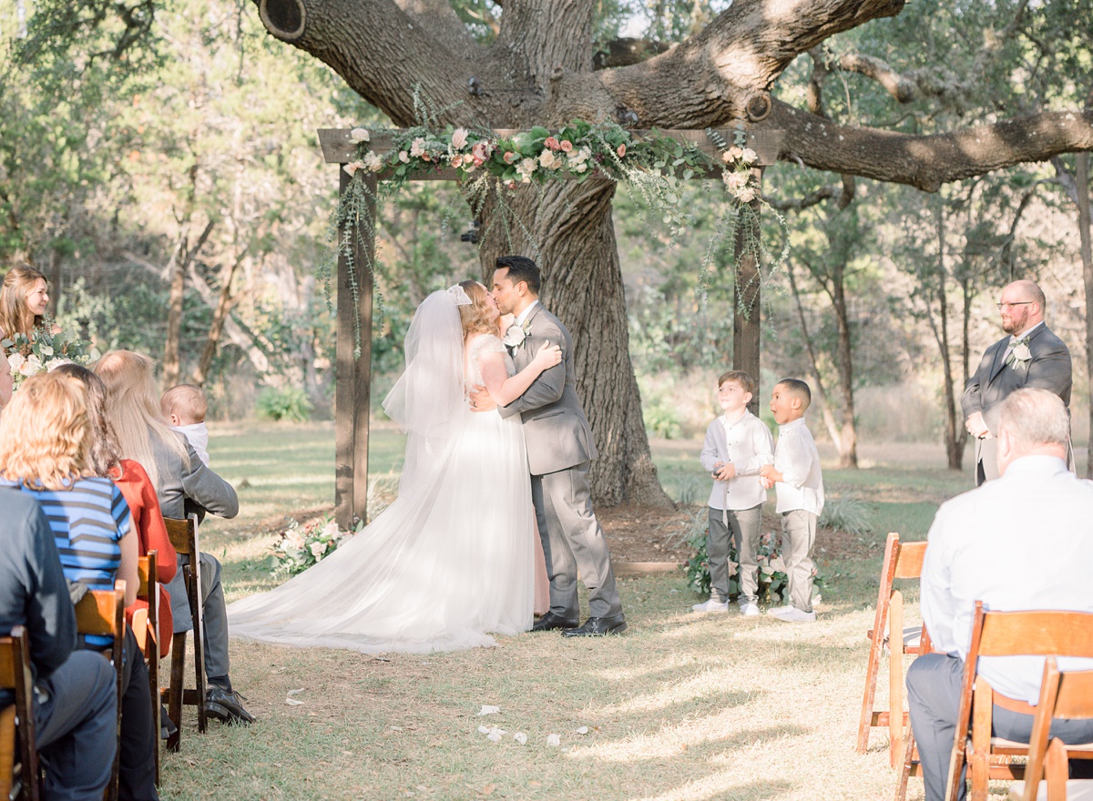 first kiss as husband and wife, the ivory oak hill country wedding venue, tara lyons photography