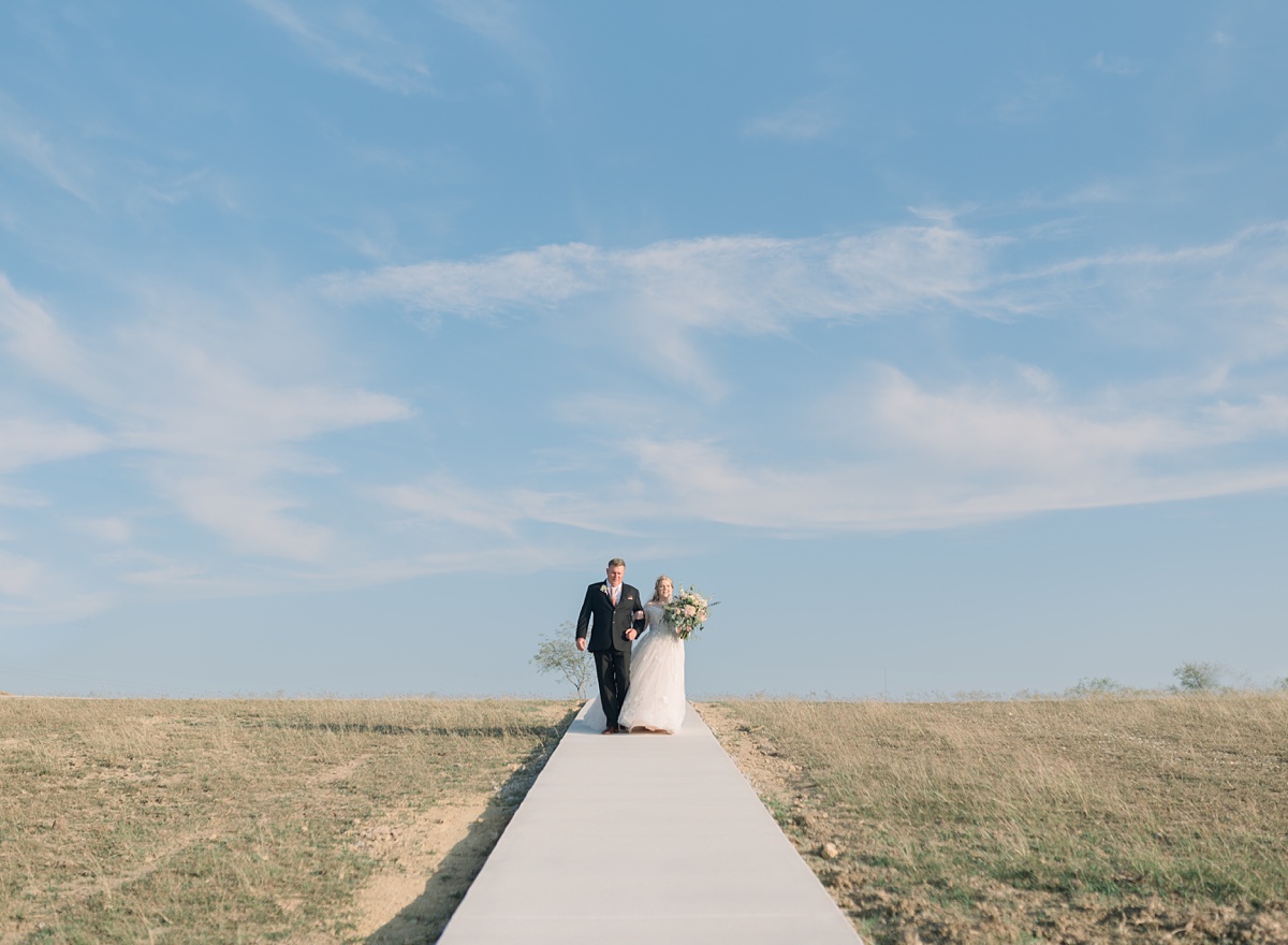 bride walking down aisle - Blue Hills Ranch Fall wedding near Waco, TX