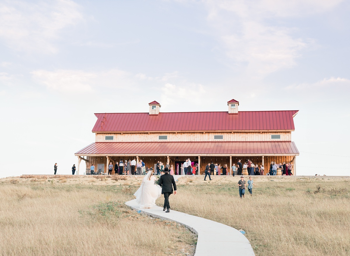 bride and groom entering reception - Blue Hills Ranch Fall wedding near Waco, TX
