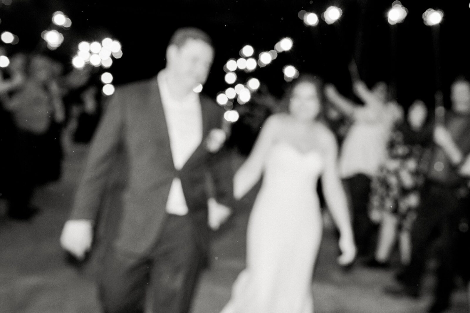 blurry wedding photos, wedding photography trends, blurry wedding photography trend, black and white sparkler exit, reception dancing, guests dancing at wedding, videre estate reception space, wedding at the videre estate venue, wimberley, 