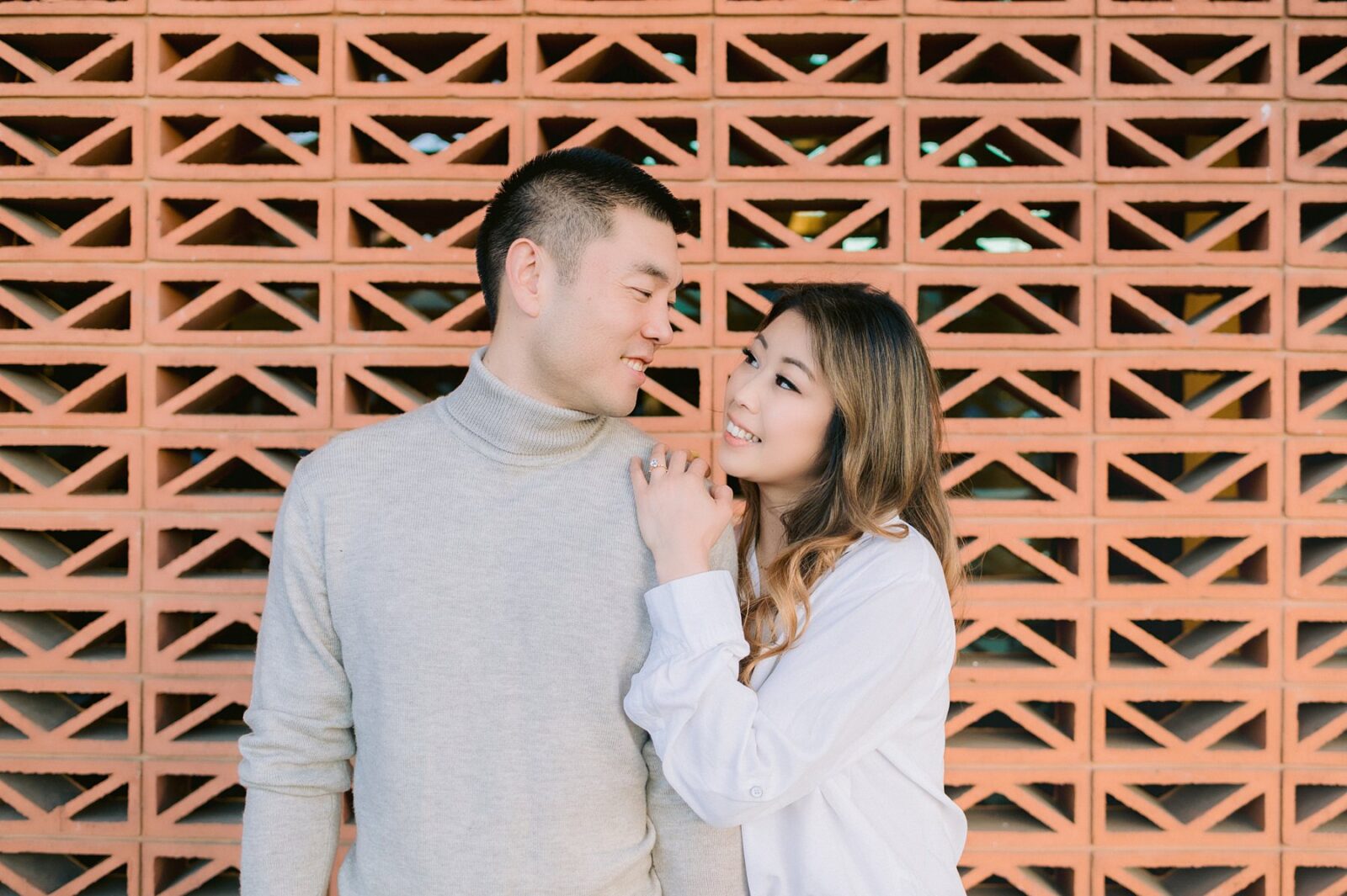south congress hotel engagement photos, engagement session next to art deco brick wall, south austin engagement, neutral engagement session outfit, photos by Tara Lyons Photography, austin wedding photographer