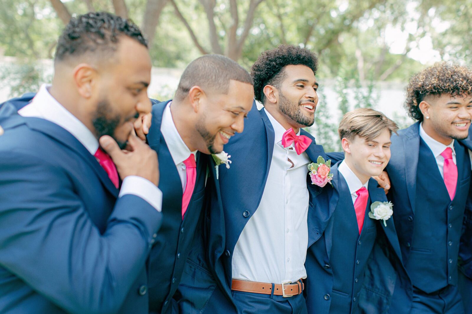 groom and groomsmen with arms around each other