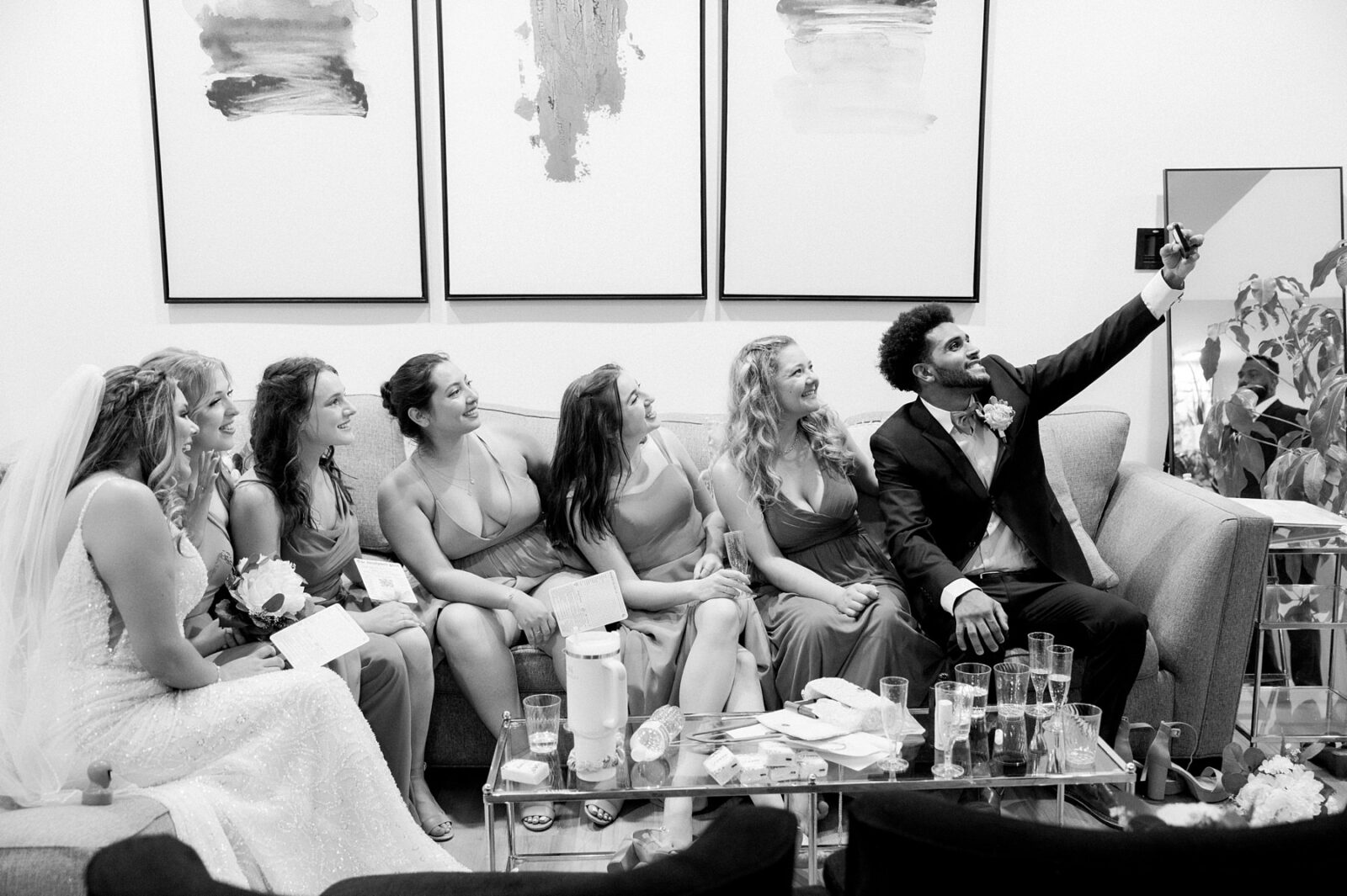 groom taking selfie with bride and bridesmaids in the bridal suite at hummingbird house