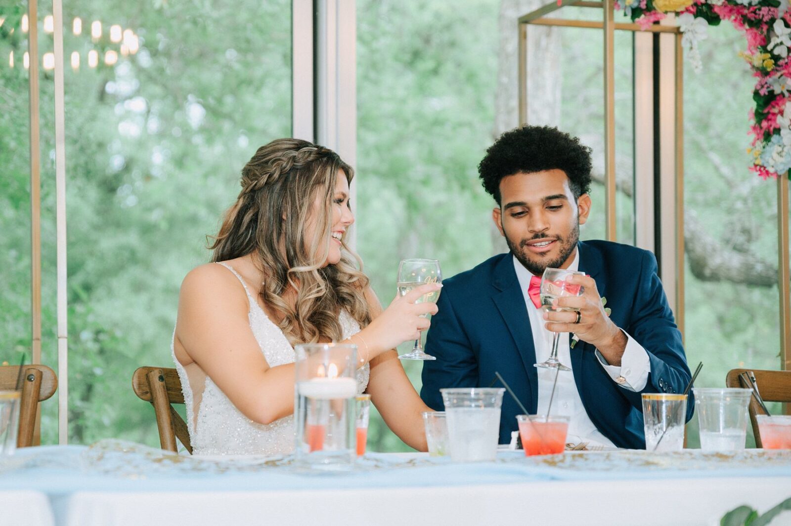 bride and groom toasting drinks together at austin wedding