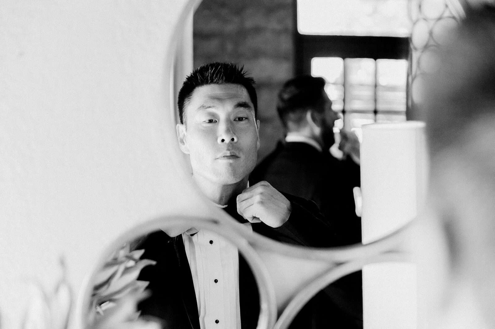 groom getting ready in mirror, black and white groom photos, stonehouse villa, wimberley wedding venue, tara paige weddings, austin wedding photographer