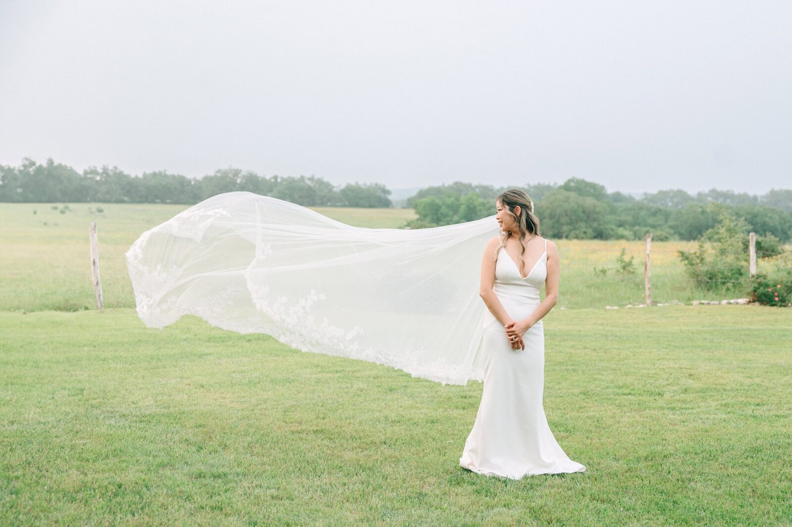 bride with veil blowing in the wind, bridal veil photo, bride and groom formal photos, formal photos at stonehouse villa, stonehouse villa wedding photos, stonehouse villa, wimberley wedding venue, tara paige weddings, austin wedding photographer