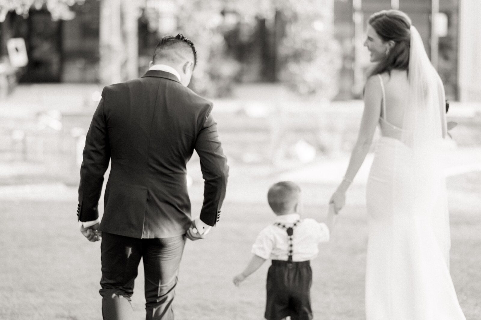 black and white wedding photos, blurry wedding photo trend, bride and groom with son